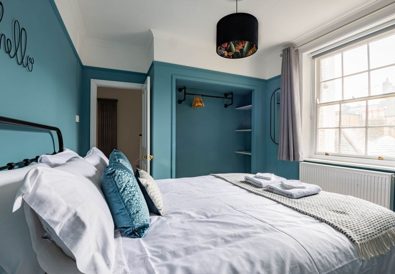 Teal king bedroom with sash window