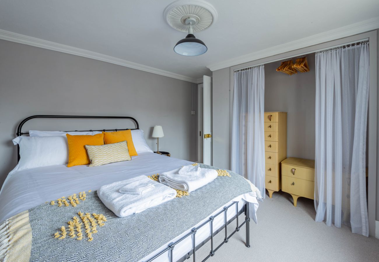 King bedroom dressed with yellow accents