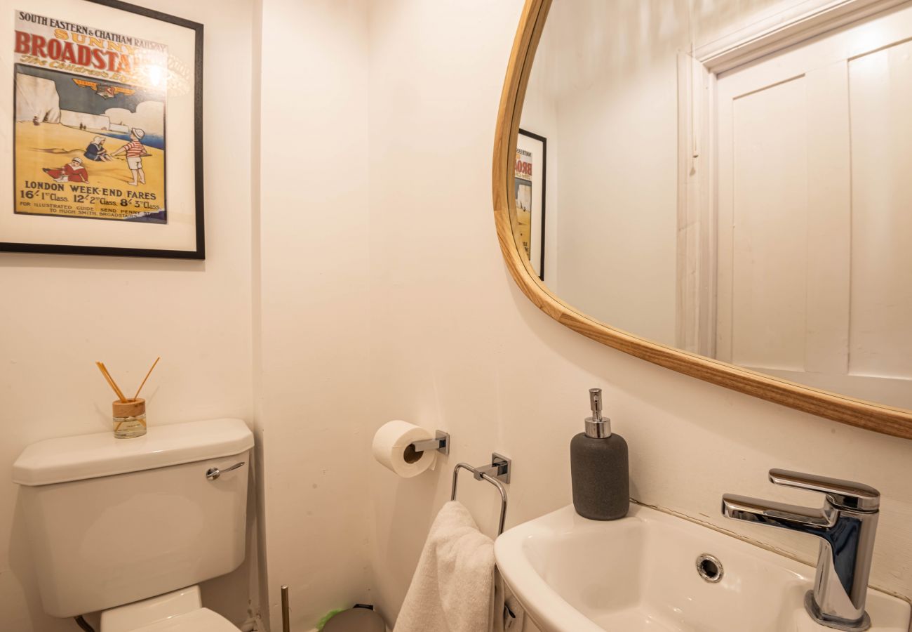 Separate WC with round mirror and Broadstairs artwork